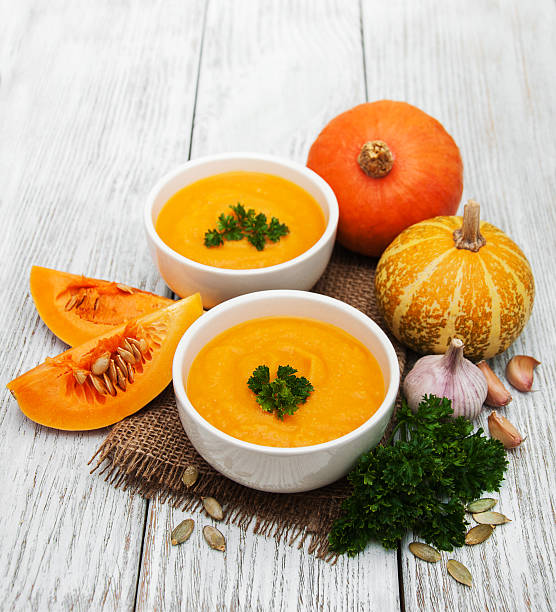 istock Pumpkin soup with fresh pumpkins 619275986