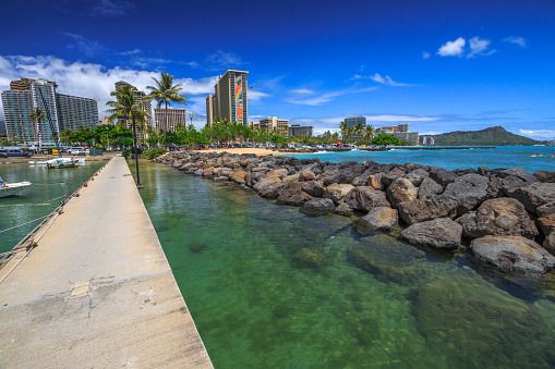 Waikiki, Oahu, Hawaii, United States - August 18, 2016: view of the Hilton Hawaiian Village and the Duke Kahanamoku Beach in Waikiki from Ala Wai Harbor the largest yacht harbor of Hawaii.