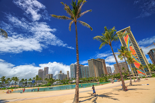 Waikiki, Oahu, Hawaii, United States - August 18, 2016: Hilton Hawaiian Village to the left of Duke Kahanamoku Beach. The beach is one of more popular of Waikiki Beaches because it offers a swimming area protected.