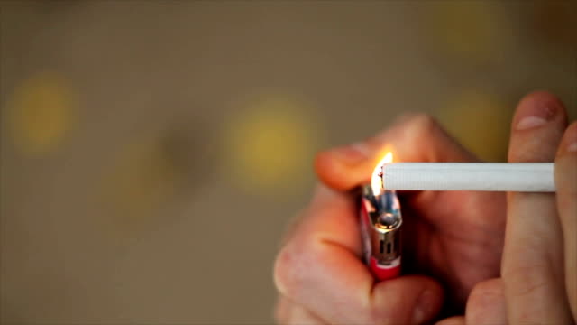 Man lights a cigarette lighter
