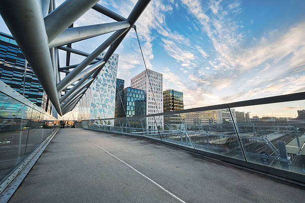 Modern Buildings in Oslo, Norway Buildings through a overhead ped crossing in Oslo bridge crossing cloud built structure stock pictures, royalty-free photos & images