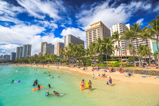 Waikiki, Oahu, Hawaii, United States - August 27, 2016: summertime in crowded Prince Kuhio Beach also called The Ponds because a concrete wall makes the water calm. Kuhio Beach is a section of Waikiki Beach.