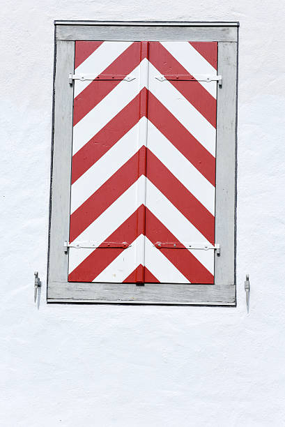 red window on white wooden wall