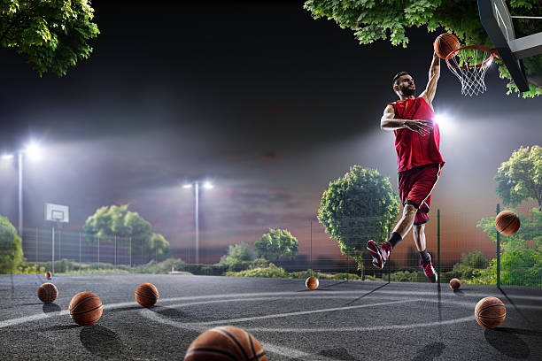 istock Basketball player is working out on night court 619371436