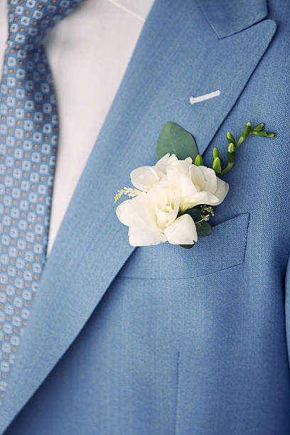 istock white buttonhole of the groom and blue suit 619371632