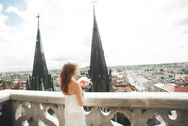 istock Beautiful luxury bride on the balcony with perfect landscape 619372516