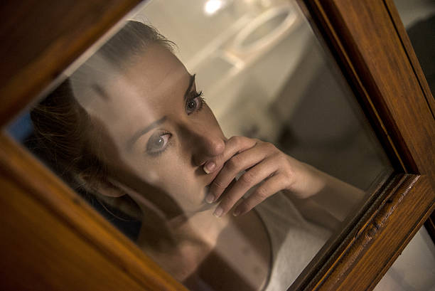 istock lonely girl near window thinking about something 619373282