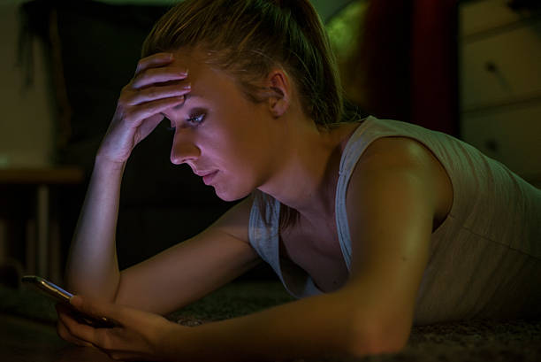 istock young sad  girl using mobile phone scared and desperate suffering 619374642