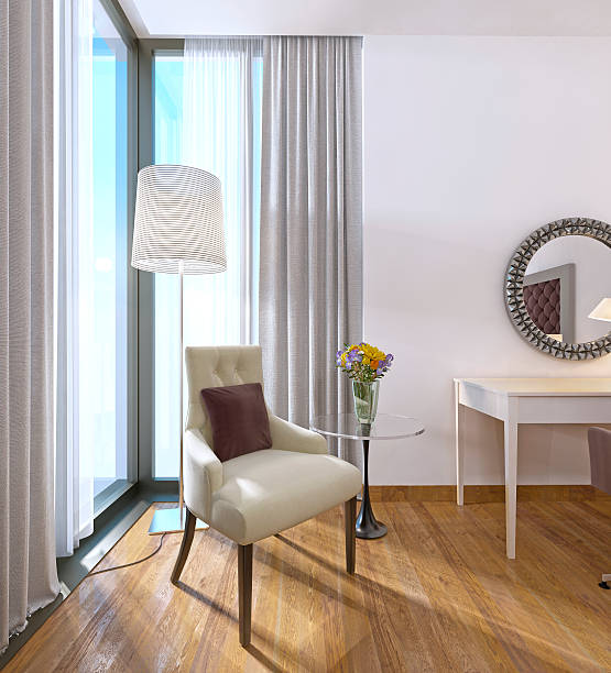 istock Modern comfortable chair with a table and lamp. 619375290