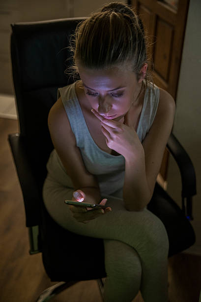 istock sad young woman with mobile phone 619375574