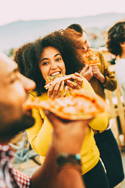istock Eating pizza at a party on the roof 619376686