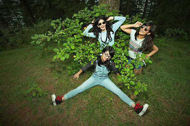 istock Happy female friends doing fun and posing in nature. 619376698