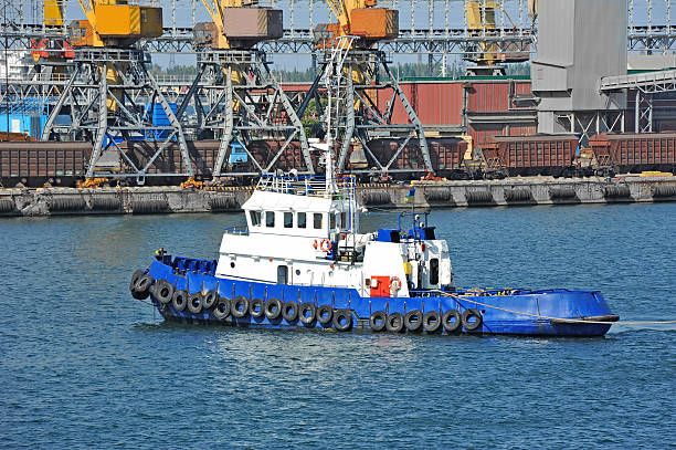 istock Tugboat and port cargo crane 619376950