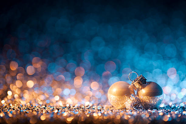 Christmas ornaments on defocused lights. Decorations Bokeh Blue Gold Five christmas ornaments on defoused gold and blue light. christmas star shape christmas lights blue stock pictures, royalty-free photos & images