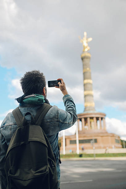 istock Tourist walking by the Berlin Victory column 619379248