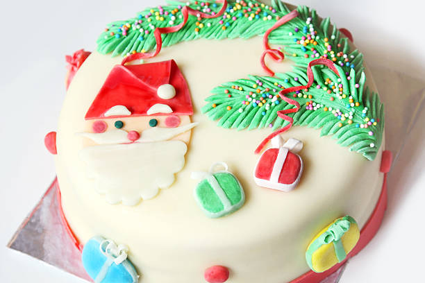 decorated with sugar paste whole christmas cake: santa, christmas tree and gifts