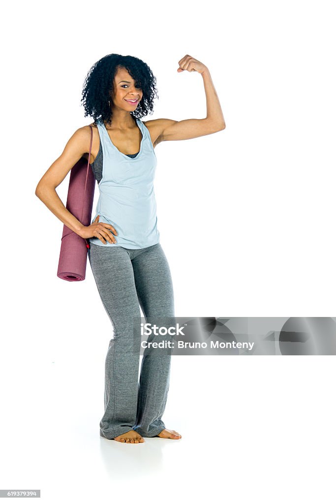 female model attractive woman showing strength with arm curl attractive woman on plein background shot in studio with soft lights with an interesting expression and dramatic lighting Adult Stock Photo