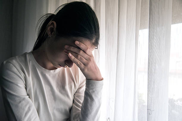 istock Pensive teenager holding head with her hand 619380960