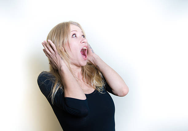 istock Stunned young woman on white portrait 619382832
