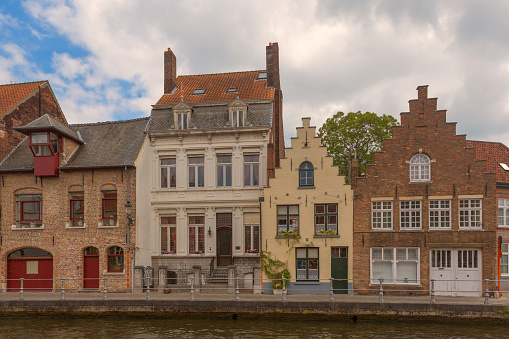 Historical gothic buildings by water channels at brugge belgium