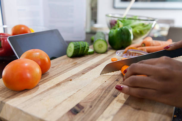 istock African women chopping carrots. 619384132