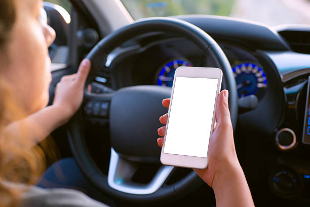 istock Woman using smart phone in car 619384454