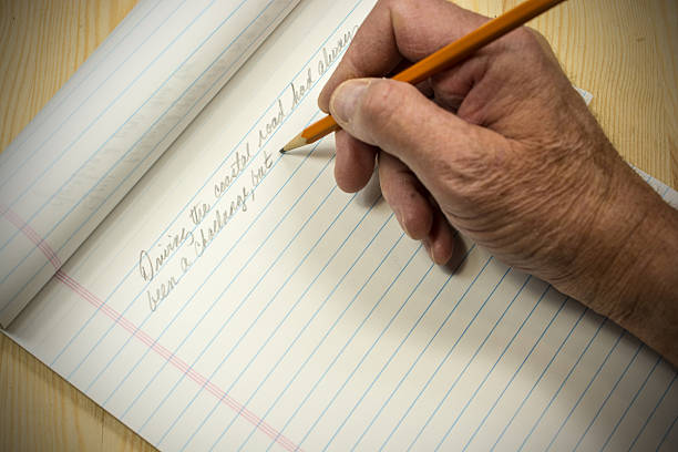 An author beginning his manuscript with pencil and pad