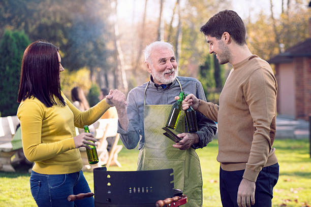 Group of active senior people having a great time outdoors during a picnic day.