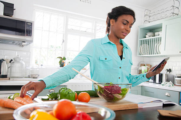istock African woman following a recipes steps. 619387190
