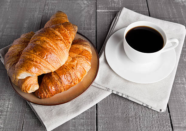 istock Cup of black coffee and croissant for breakfast 619387736