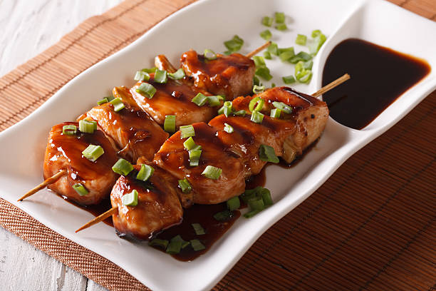 japanese food: chicken yakitori on skewers close-up. horizontal - yakitori stok fotoğraflar ve resimler