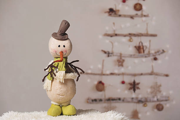 istock Snowman by the christmas tree 619396390