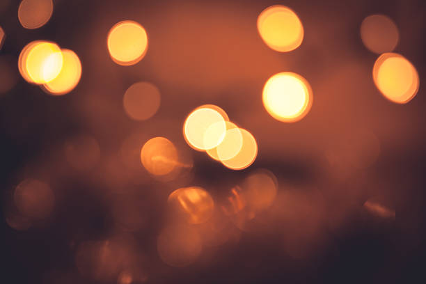 istock Warm bokeh with sparkling Christmas lights in orange colors 619398022