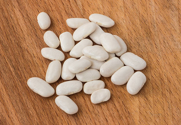 istock White beans on a wooden background 3 619398244