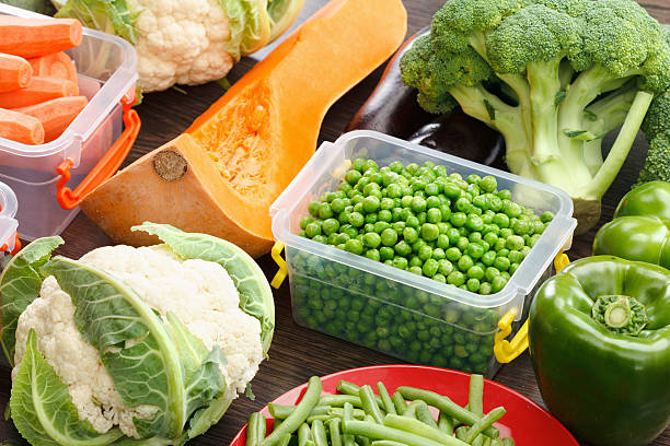 istock Trays with raw vegetables for freezing. 619401790