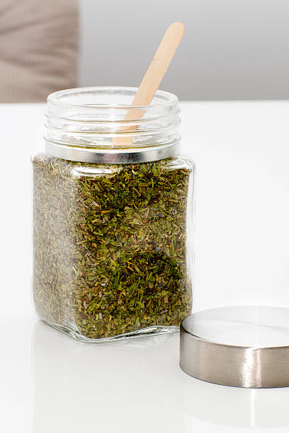 istock Herbs are in the glass jars with spoons. 619402410