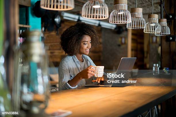 Woman Working Online At A Cafe Stock Photo - Download Image Now - Coffee Shop, Laptop, Owner