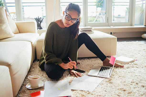 young woman studying in her living room