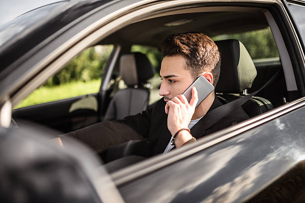 istock fashion man driving a black car 619406050