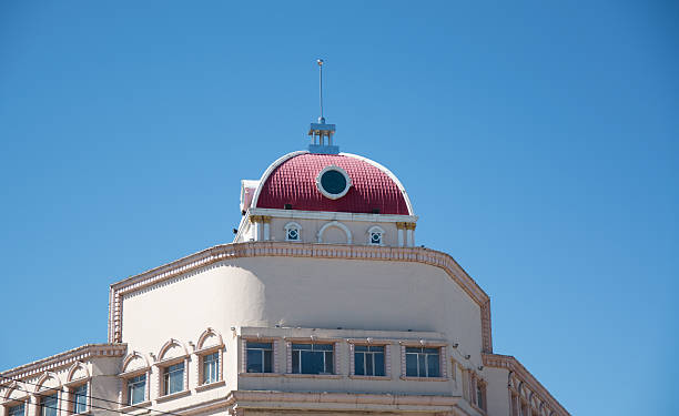istock Top of Cathedral with red dome and blue sky 619407208
