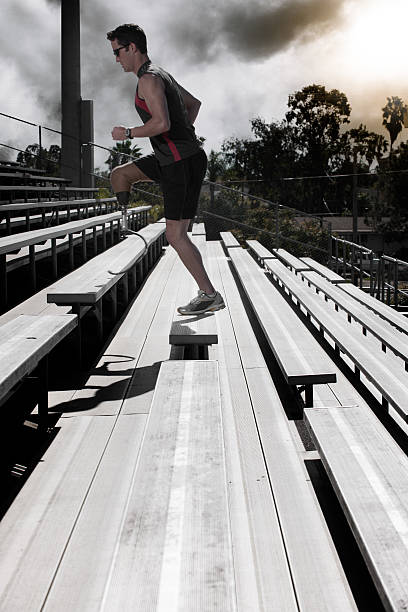 istock Athlete With Prosthetic Leg Running Up Stairs 619407726