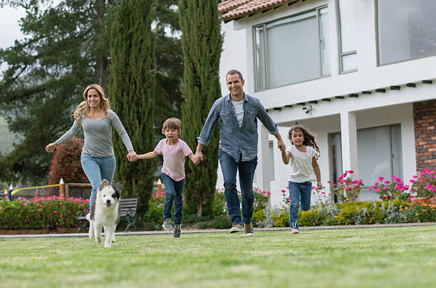 istock Happy family playing with their dog 619410956
