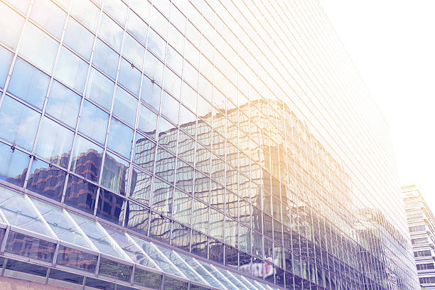 istock reflect of sunlight at abstract office building , business concept 619411258