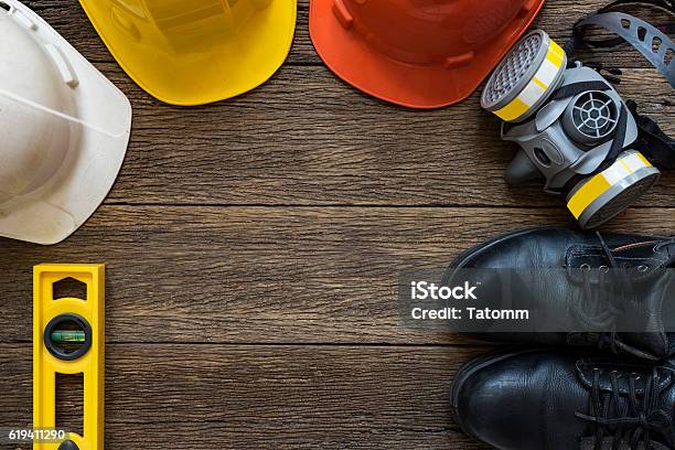 Safety Equipment On Old Wooden Table Top View Stock Photo - Download Image Now - Working, Occupation, Shoe