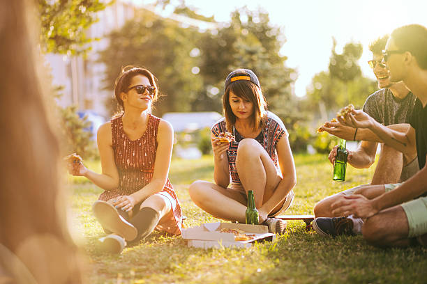 istock Happy Young Friends in Sunny Field 619413154