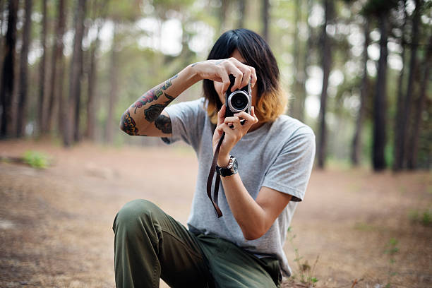 istock Asian Photographer Taking Pictures Outdoors Concept 619497524