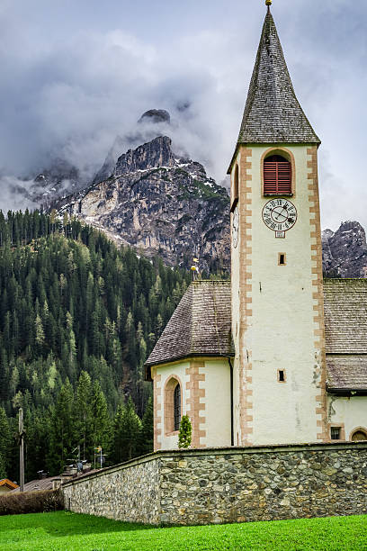 istock Small church in cloudy mountain Dolomites, Italy 619499670