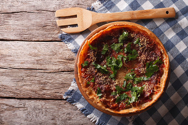 istock Chicago deep dish pizza on the table. horizontal top view 619501460