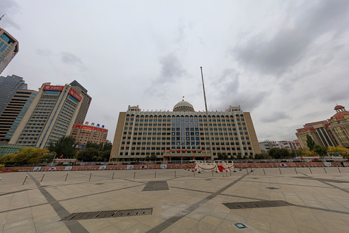 Urumqi, Xinjiang, China- October 13, 2016: Urumqi downtown city square view, Government and business buildings on the background, incidental people on the background.