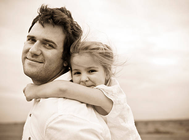 Happy young father with little daughter outdoors